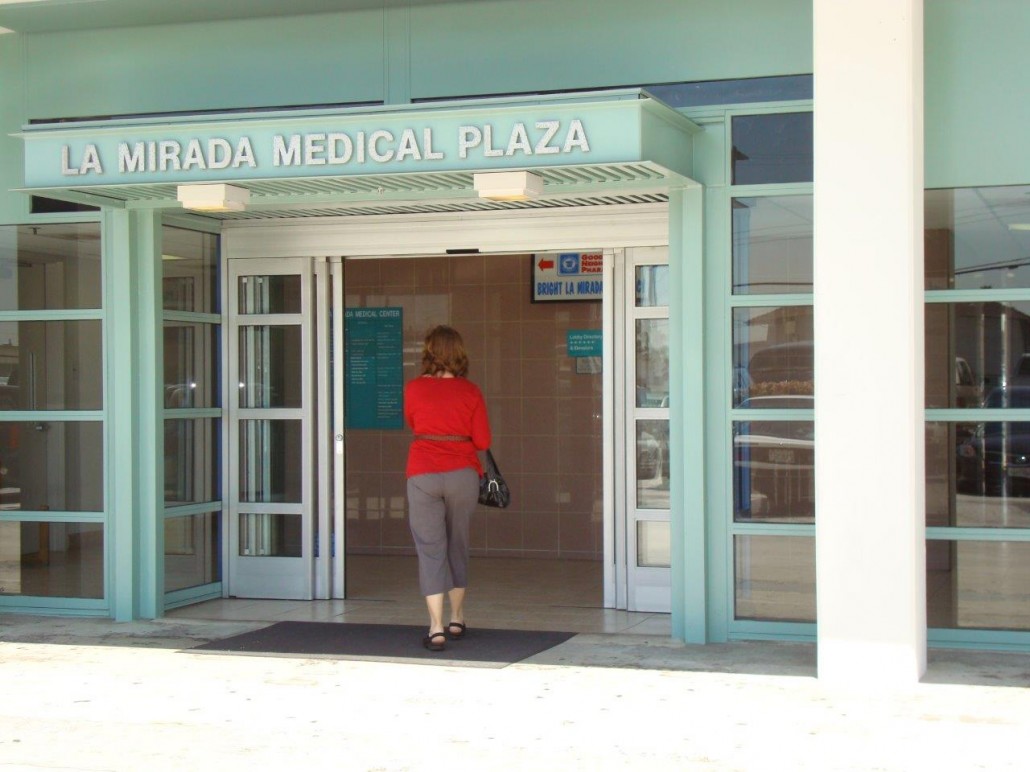 A woman entering the La Mirada Medical Plaza
