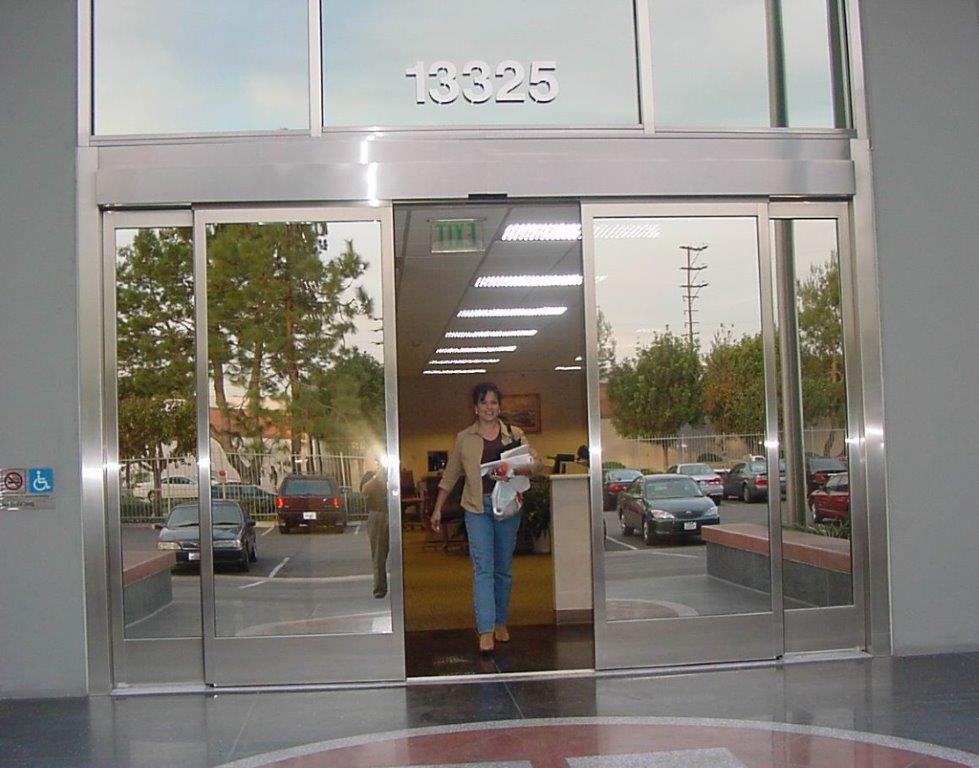 Stainless Steel Clad Bi-parting package doors with reflective glass and Recessed Sensors