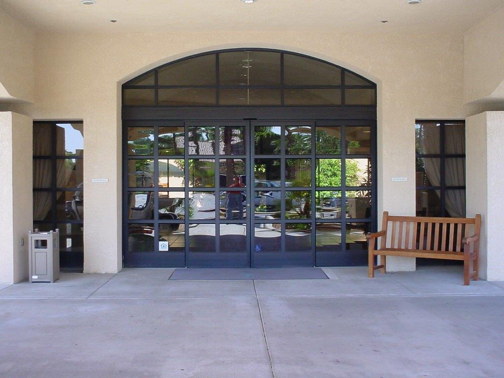 Large black automated doors with glass panes