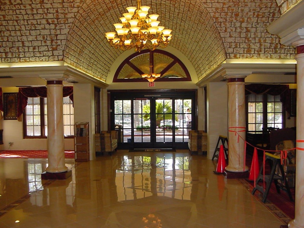 A lobby of a building with chandeliers
